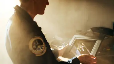 Michael Foale looks at a photograph of the International Space Station ISS.